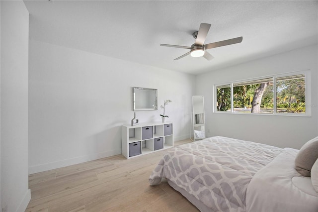 bedroom featuring ceiling fan and light hardwood / wood-style flooring