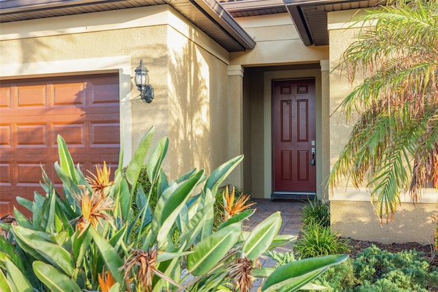 view of exterior entry featuring a garage