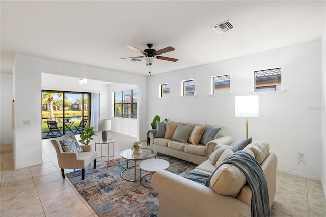 tiled living room featuring ceiling fan