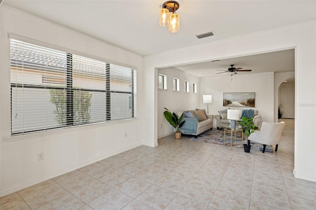 tiled living room featuring ceiling fan