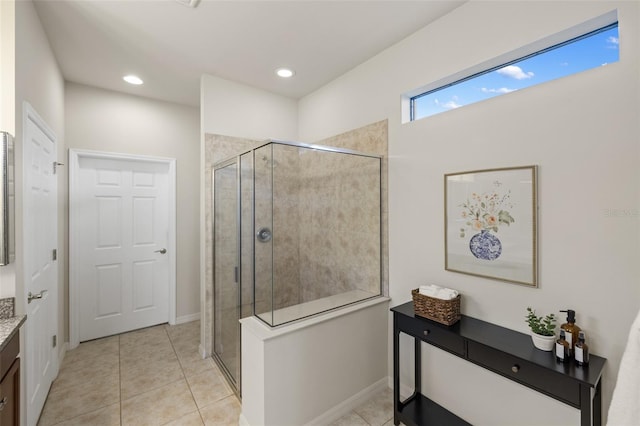 bathroom with vanity, tile patterned floors, and a shower with door