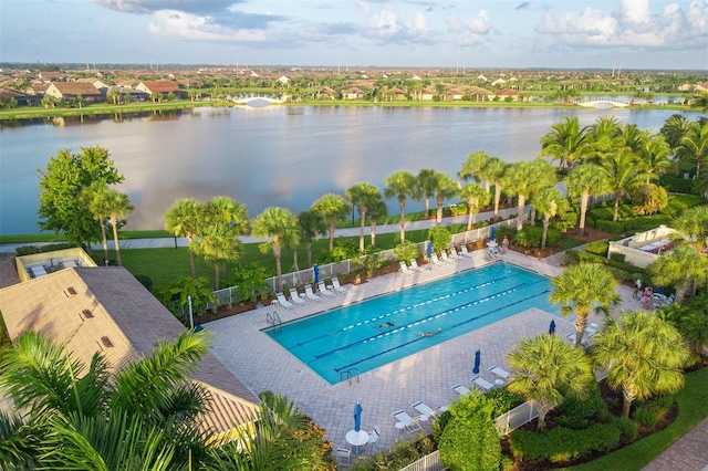 view of pool with a water view and a patio