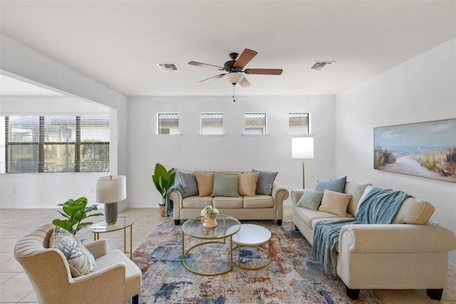 tiled living room with ceiling fan