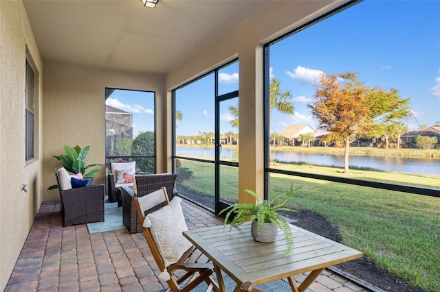 sunroom / solarium with a water view