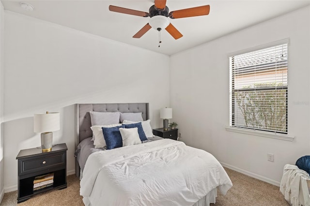 bedroom featuring light colored carpet and ceiling fan