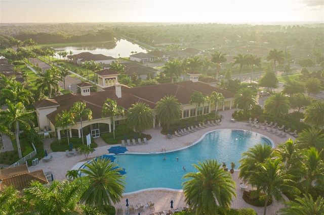 view of pool featuring a patio and a water view