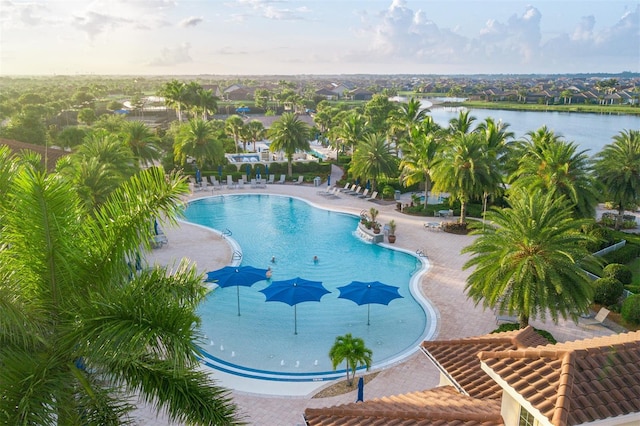 view of pool featuring a patio and a water view