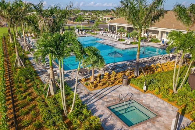 view of swimming pool with a patio and a community hot tub