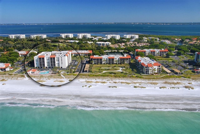 aerial view with a water view and a view of the beach