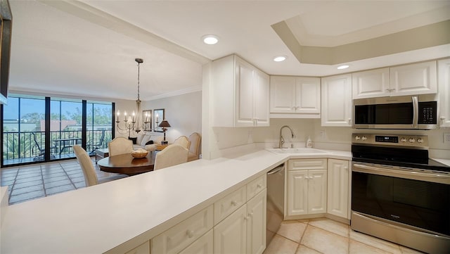 kitchen with ornamental molding, sink, an inviting chandelier, light tile patterned floors, and appliances with stainless steel finishes