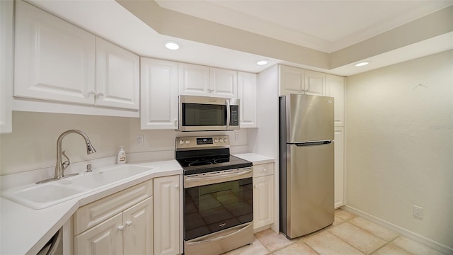 kitchen featuring white cabinetry, light tile patterned floors, stainless steel appliances, and sink