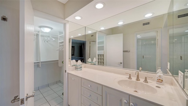 bathroom with vanity, tile patterned floors, and an enclosed shower