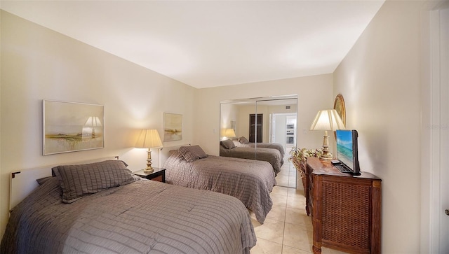 bedroom featuring a closet and light tile patterned floors