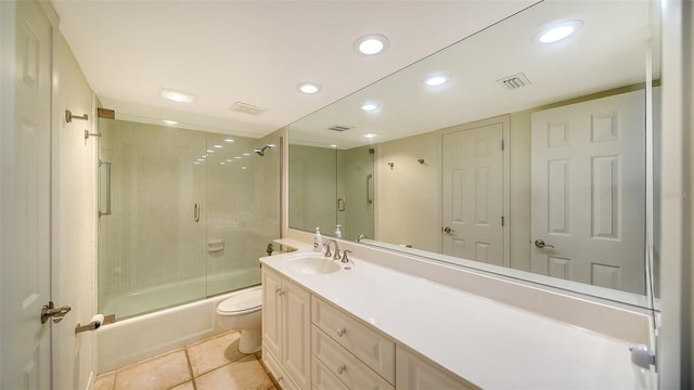 full bathroom featuring toilet, combined bath / shower with glass door, vanity, and tile patterned floors