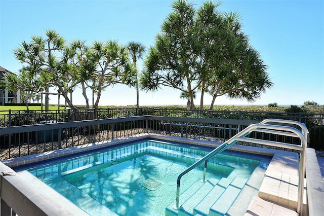 view of pool featuring an in ground hot tub