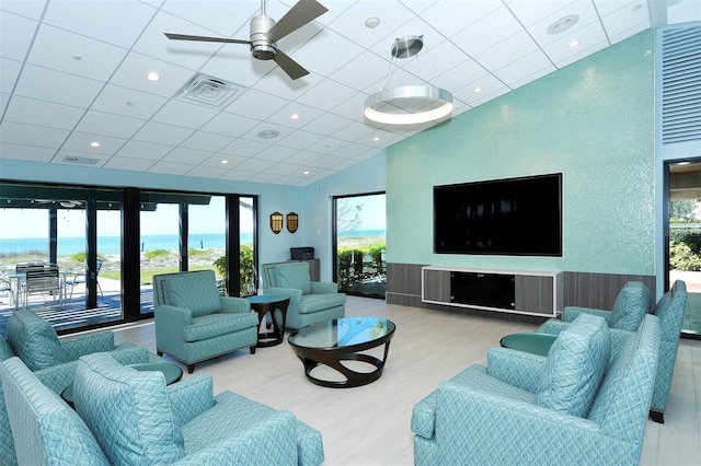 living room with hardwood / wood-style floors, a water view, and ceiling fan