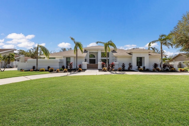 mediterranean / spanish home with a front yard