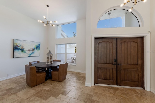 entrance foyer featuring a high ceiling and an inviting chandelier