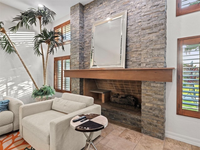 living room featuring a stone fireplace