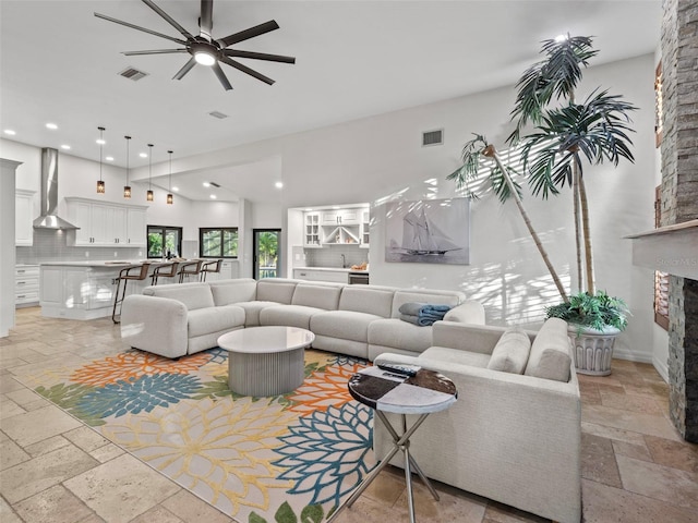 living room with a fireplace and ceiling fan