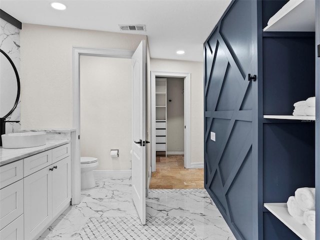 bathroom with toilet and vanity