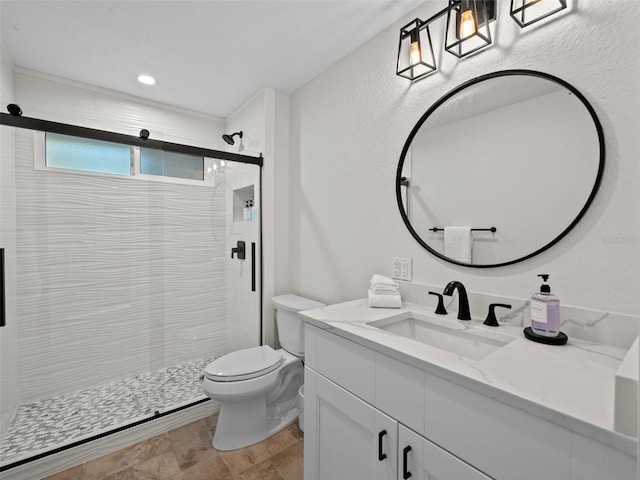 bathroom featuring an enclosed shower, vanity, and toilet