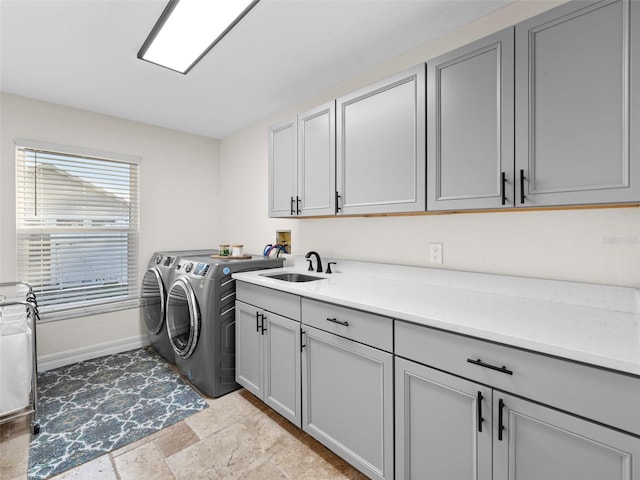 laundry area with cabinets, sink, and independent washer and dryer