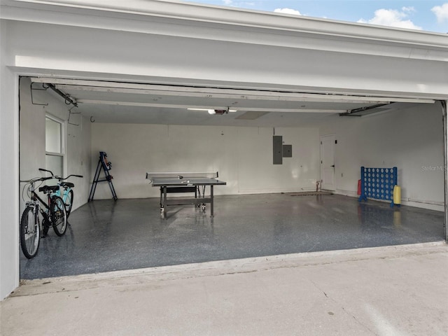 garage featuring electric panel and a garage door opener