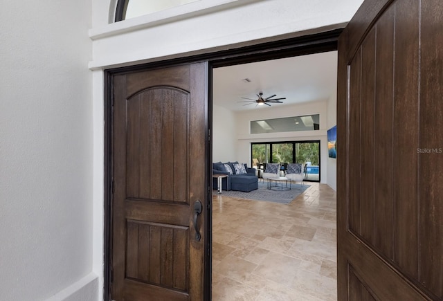 interior space featuring outdoor lounge area and ceiling fan