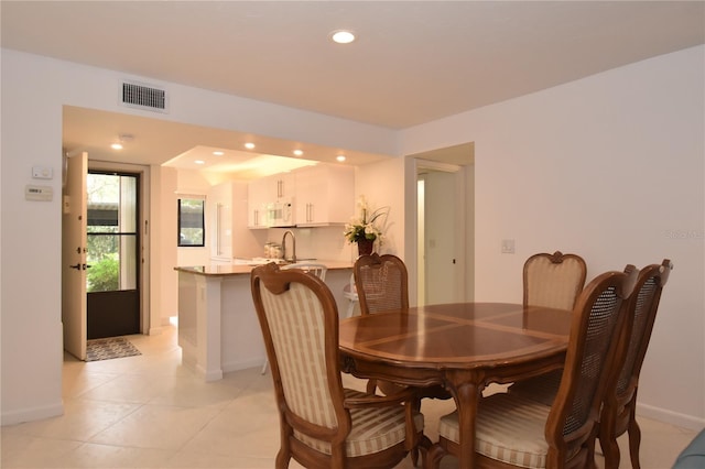 dining area featuring light tile patterned floors