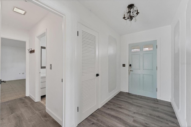 entryway with a notable chandelier and hardwood / wood-style flooring