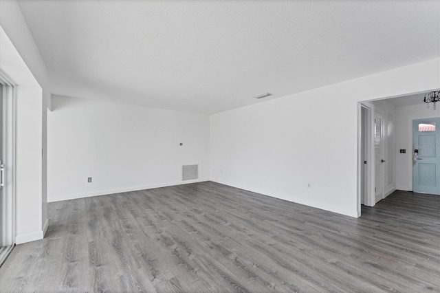 unfurnished room featuring light hardwood / wood-style floors and an inviting chandelier