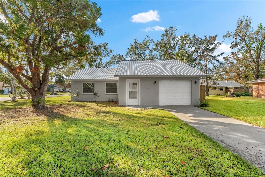 ranch-style home featuring a garage and a front lawn