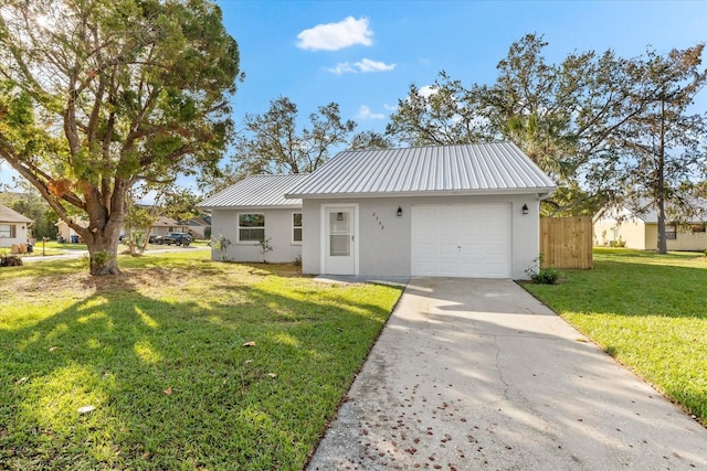 view of front of house with a garage and a front lawn