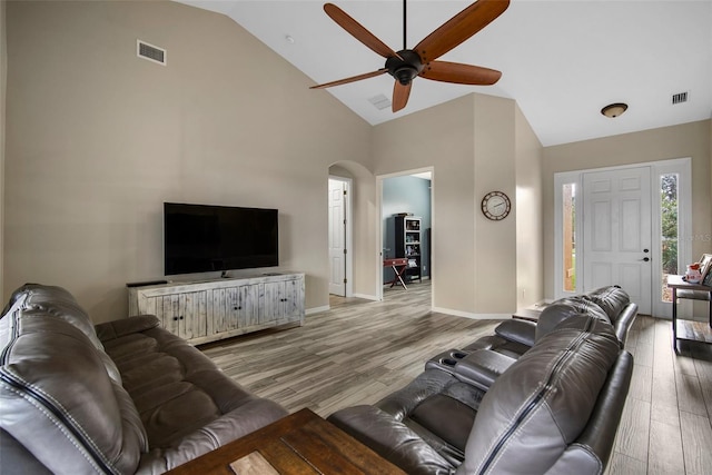 living room with high vaulted ceiling, light wood-type flooring, and ceiling fan