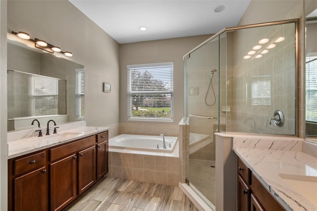 bathroom featuring vanity, plus walk in shower, and wood-type flooring