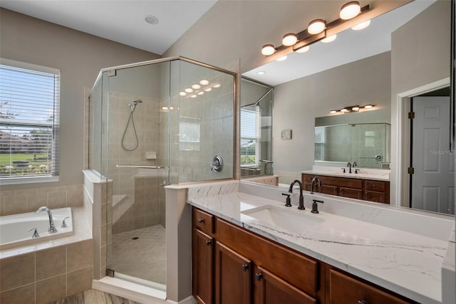 bathroom with vanity and separate shower and tub