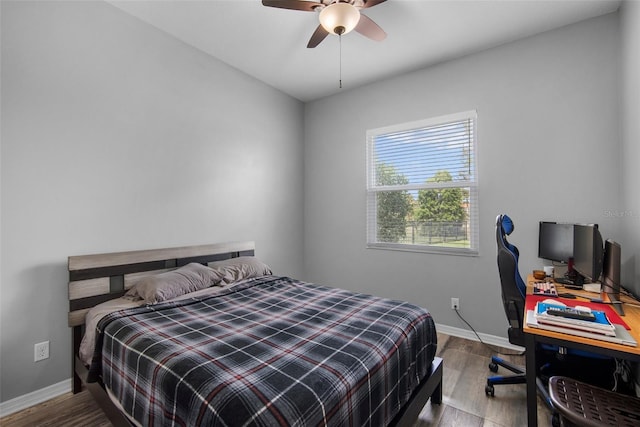 bedroom with ceiling fan and hardwood / wood-style floors