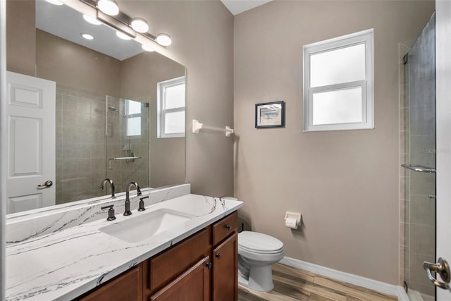 bathroom with toilet, an enclosed shower, hardwood / wood-style flooring, and vanity