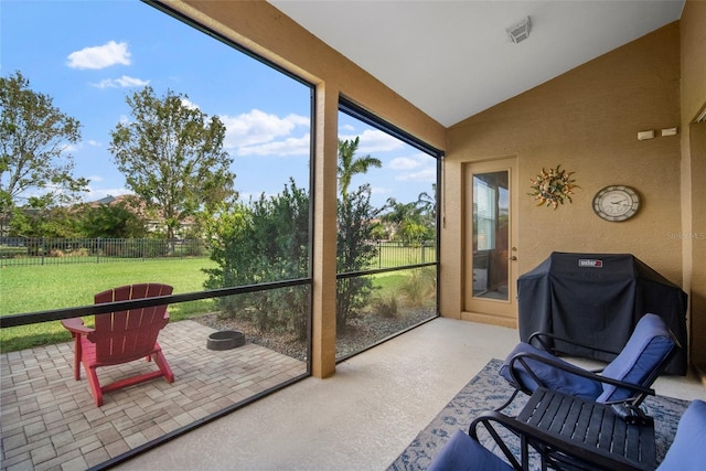 sunroom featuring lofted ceiling