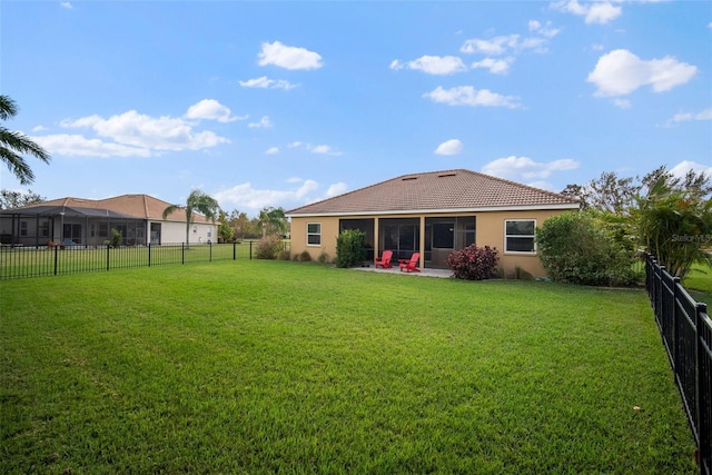 back of house with a patio, a lanai, and a yard