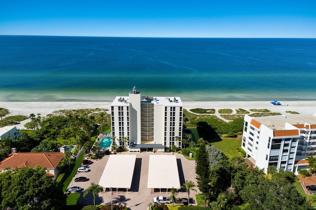 drone / aerial view featuring a water view and a view of the beach