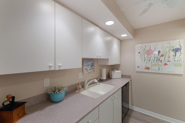 kitchen featuring stainless steel dishwasher, light hardwood / wood-style flooring, white cabinets, and sink