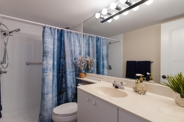 bathroom with vanity, toilet, and walk in shower