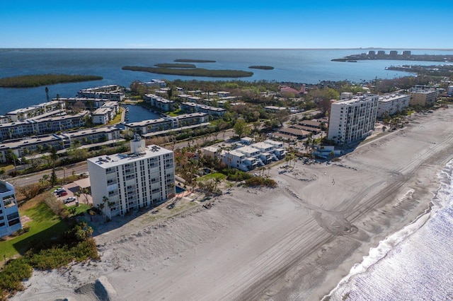 birds eye view of property featuring a water view and a beach view