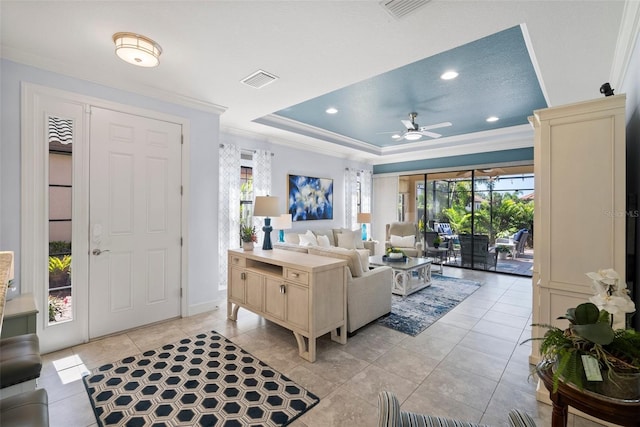 tiled living room with a wealth of natural light, crown molding, and ceiling fan