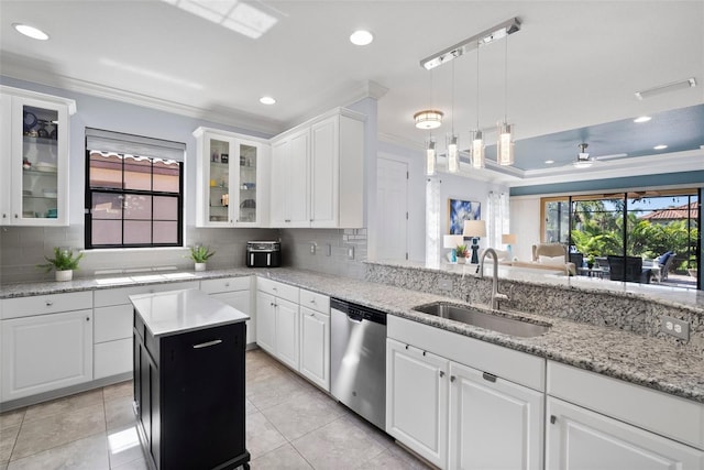 kitchen featuring sink, a wealth of natural light, stainless steel dishwasher, and white cabinets