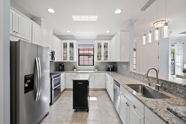 kitchen featuring sink, appliances with stainless steel finishes, crown molding, and white cabinetry