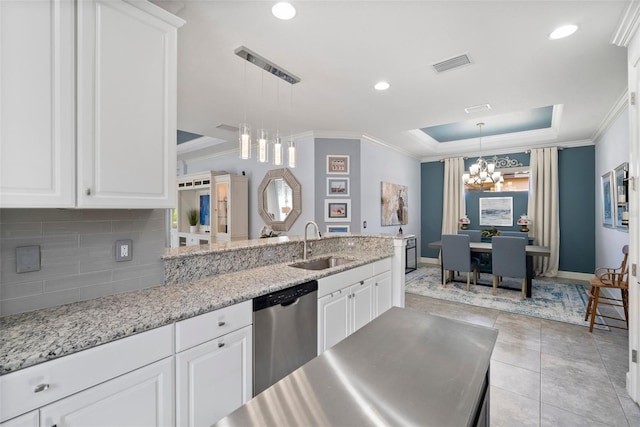 kitchen with sink, dishwasher, white cabinets, and a notable chandelier