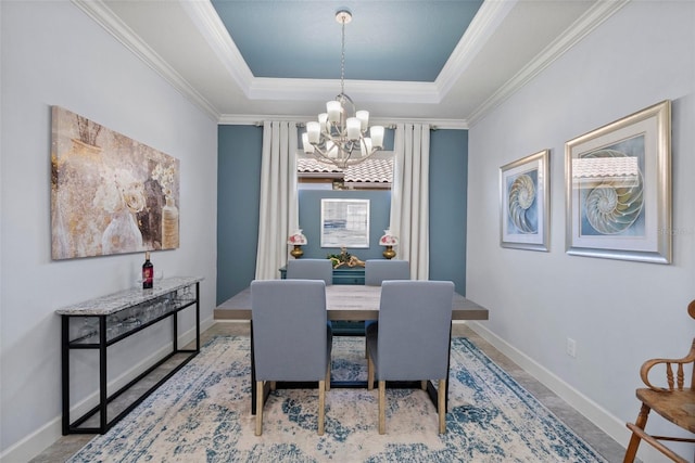 dining area featuring an inviting chandelier, a raised ceiling, and crown molding